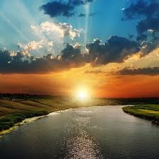 River at sunset through agricultural landscape